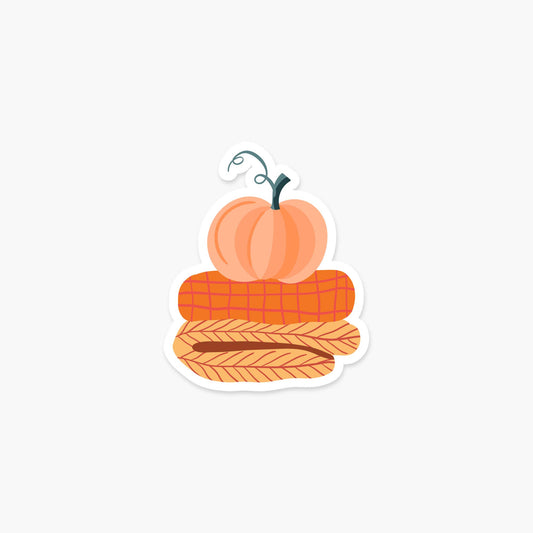 Pile of blankets with a pumpkin on top 3.25 x 2.6 in Sticker